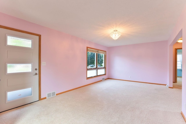 864 Howard St N, Saint Paul, MN 55119 - carpeted spare room featuring baseboards and a chandelier