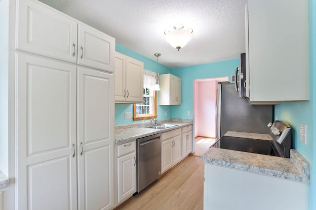 864 Howard St N, Saint Paul, MN 55119 - kitchen with stainless steel dishwasher, electric stove, a sink, light wood-style floors, and a textured ceiling