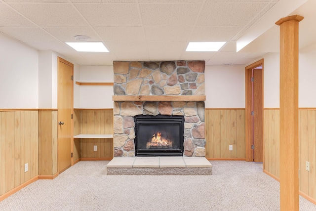 864 Howard St N, Saint Paul, MN 55119 - unfurnished living room featuring carpet, wainscoting, a fireplace, a drop ceiling, and wood walls