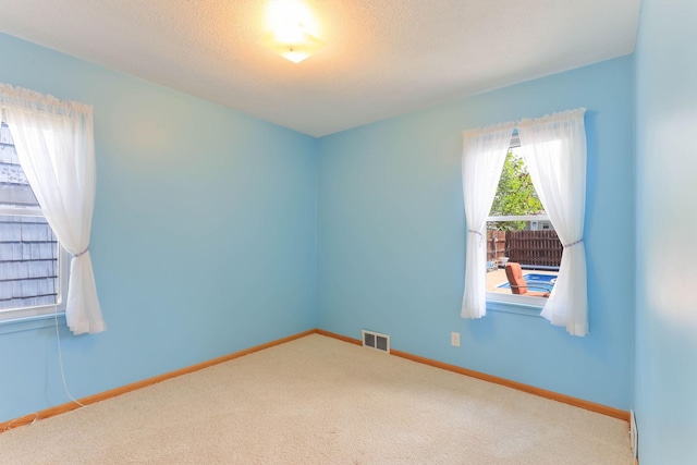 864 Howard St N, Saint Paul, MN 55119 - carpeted spare room with baseboards and a textured ceiling