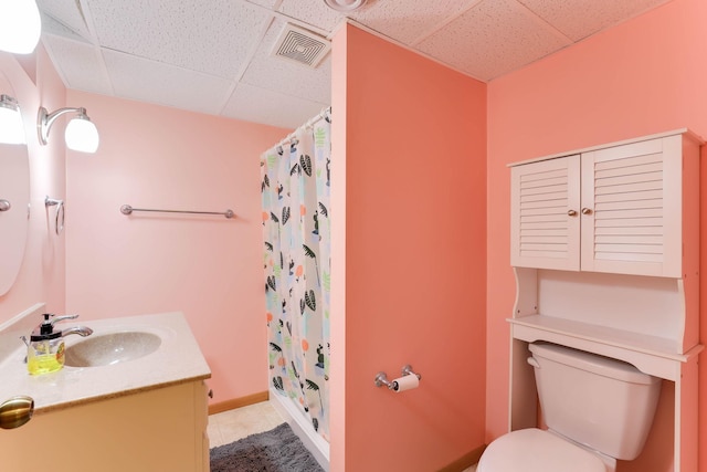 864 Howard St N, Saint Paul, MN 55119 - bathroom with a paneled ceiling, vanity, toilet, tile patterned floors, and a shower with curtain