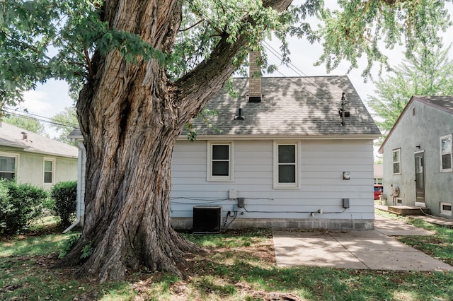 1651 5th St E, Saint Paul, MN 55106 - back of property with a patio, central AC unit, and a shingled roof