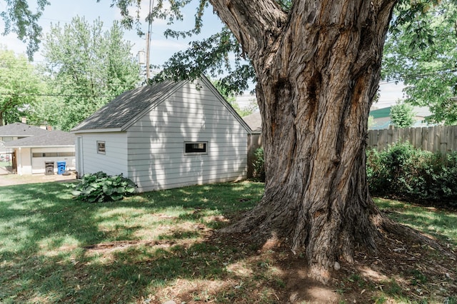 1651 5th St E, Saint Paul, MN 55106 - view of side of home with a shingled roof and an outbuilding