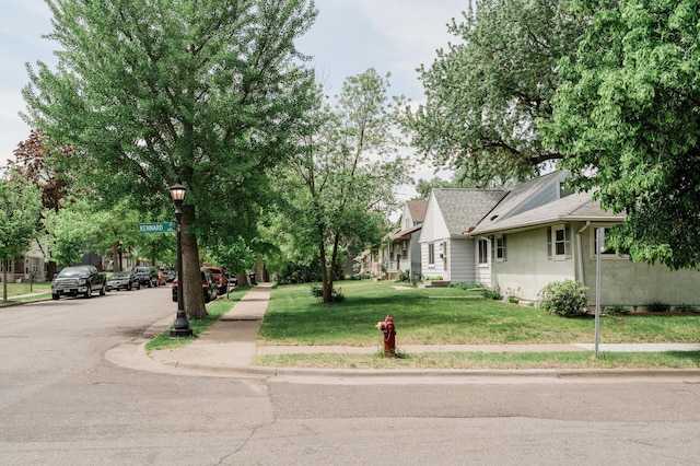 1651 5th St E, Saint Paul, MN 55106 - view of front of house featuring a front yard and stucco siding