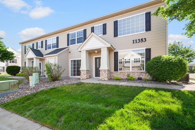 11353 Fergus St NE Unit A, Blaine, MN 55449 - view of front of property featuring a front lawn and stone siding
