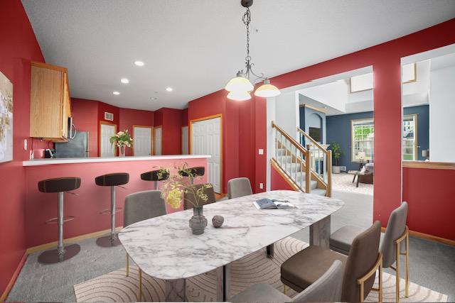 11353 Fergus St NE Unit A, Blaine, MN 55449 - dining space featuring carpet flooring, stairs, recessed lighting, and baseboards