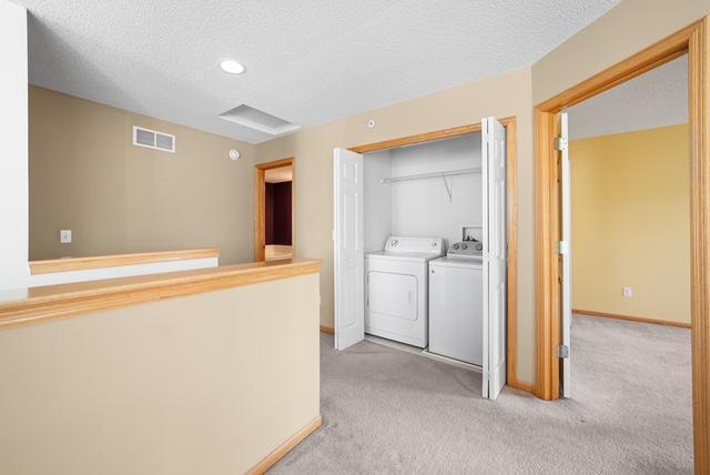 11353 Fergus St NE Unit A, Blaine, MN 55449 - laundry room featuring independent washer and dryer, light colored carpet, a textured ceiling, recessed lighting, and baseboards