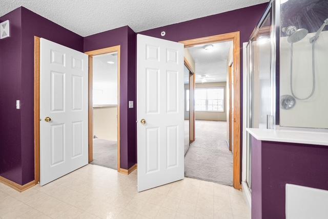 11353 Fergus St NE Unit A, Blaine, MN 55449 - hallway featuring light colored carpet and baseboards