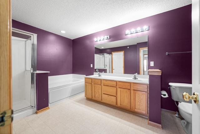 11353 Fergus St NE Unit A, Blaine, MN 55449 - bathroom featuring a textured ceiling, toilet, a stall shower, double vanity, and a bath