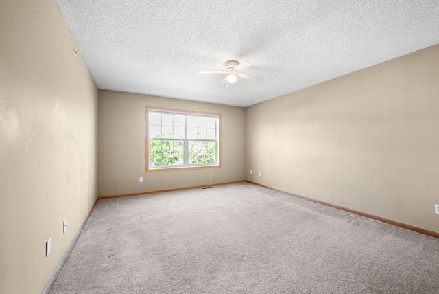 11353 Fergus St NE Unit A, Blaine, MN 55449 - unfurnished room with ceiling fan, carpet flooring, a textured ceiling, and baseboards