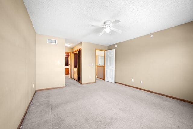 11353 Fergus St NE Unit A, Blaine, MN 55449 - empty room featuring ceiling fan, baseboards, light carpet, and a textured ceiling