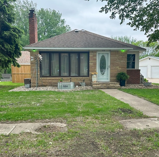 210 3rd St NE, Clara City, MN 56222 - bungalow-style home featuring entry steps, a chimney, a shingled roof, central air condition unit, and an outdoor structure