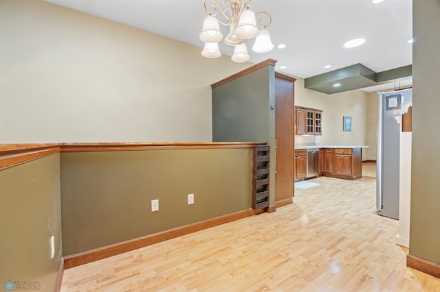 1395 Highpointe Dr N, Fargo, ND 58102 - kitchen with brown cabinets, dishwasher, light wood-type flooring, baseboards, and a chandelier