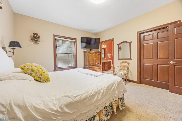 1395 Highpointe Dr N, Fargo, ND 58102 - bedroom featuring light carpet, ensuite bath, and baseboards