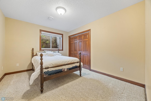 1395 Highpointe Dr N, Fargo, ND 58102 - carpeted bedroom with baseboards, a closet, and a textured ceiling