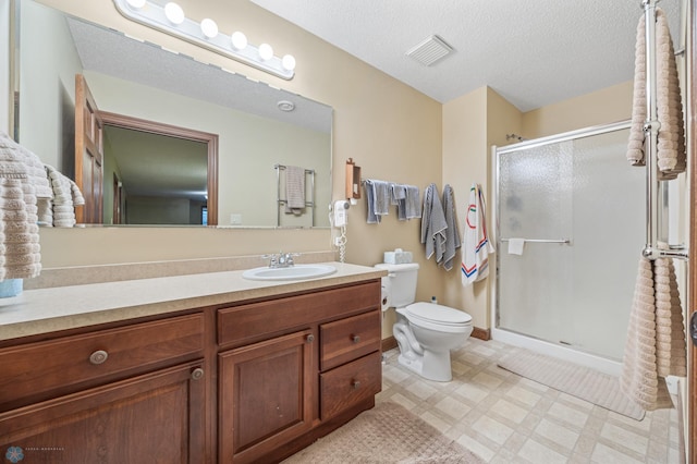 1395 Highpointe Dr N, Fargo, ND 58102 - bathroom featuring toilet, vanity, a shower stall, tile patterned floors, and a textured ceiling