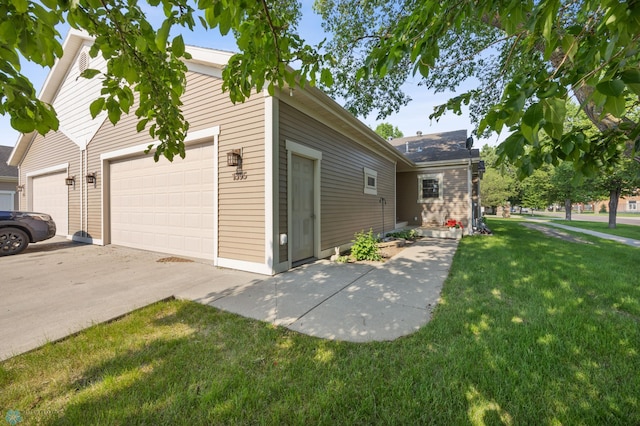 1395 Highpointe Dr N, Fargo, ND 58102 - view of side of property featuring a lawn, concrete driveway, and an attached garage