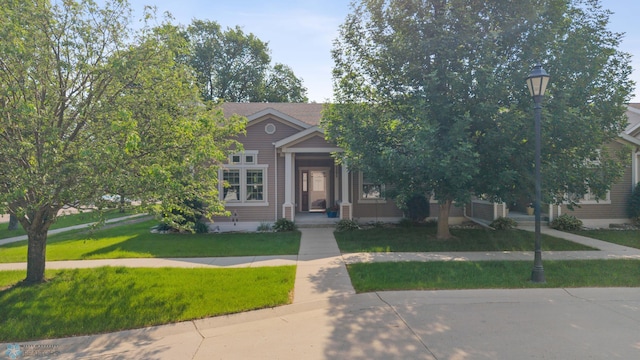 1395 Highpointe Dr N, Fargo, ND 58102 - obstructed view of property featuring a front lawn and covered porch