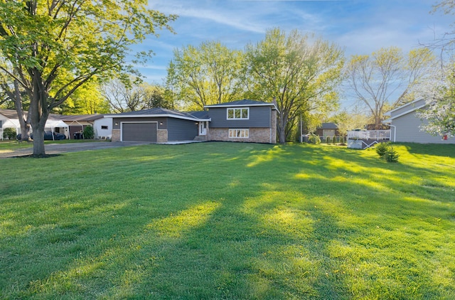 8464 Greenwood Dr, Mounds View, MN 55112 - view of grassy yard featuring a garage and driveway