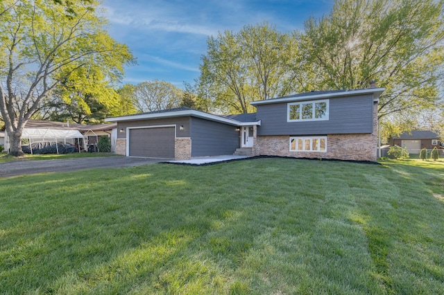 8464 Greenwood Dr, Mounds View, MN 55112 - split level home with an attached garage, brick siding, a front lawn, and asphalt driveway