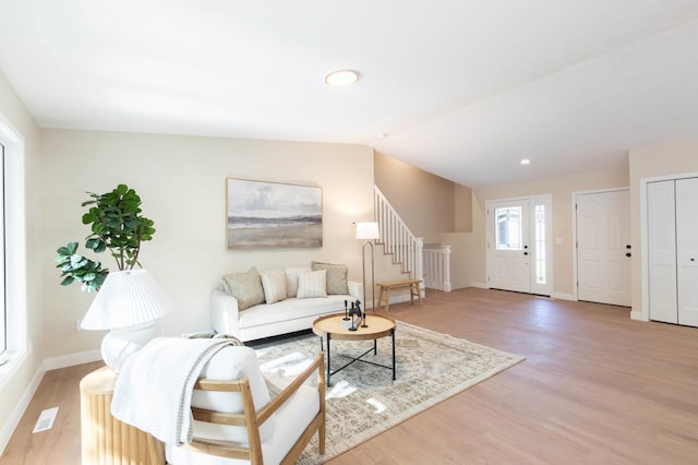 8464 Greenwood Dr, Mounds View, MN 55112 - living area with baseboards, light wood-style floors, stairs, recessed lighting, and vaulted ceiling