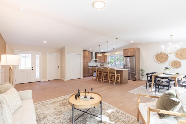 8464 Greenwood Dr, Mounds View, MN 55112 - living room with vaulted ceiling, light wood-type flooring, and a chandelier
