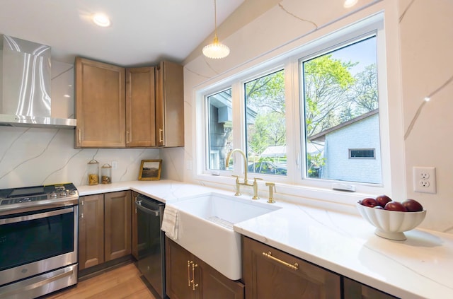 8464 Greenwood Dr, Mounds View, MN 55112 - kitchen featuring stainless steel range with gas stovetop, wall chimney range hood, dishwasher, a sink, and tasteful backsplash