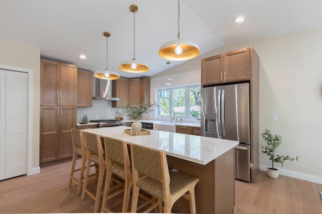 8464 Greenwood Dr, Mounds View, MN 55112 - kitchen with stainless steel appliances, wall chimney exhaust hood, light wood-type flooring, a breakfast bar, and recessed lighting