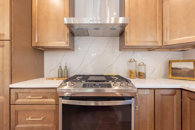8464 Greenwood Dr, Mounds View, MN 55112 - kitchen with stainless steel gas stove, exhaust hood, tasteful backsplash, and light stone counters