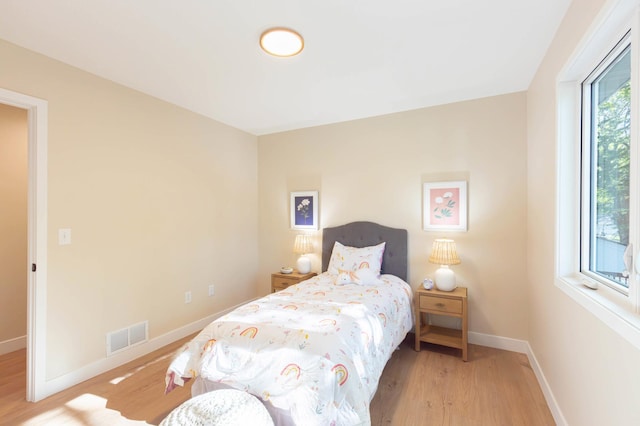 8464 Greenwood Dr, Mounds View, MN 55112 - bedroom featuring wood finished floors and baseboards