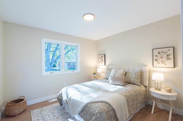 8464 Greenwood Dr, Mounds View, MN 55112 - bedroom featuring baseboards and wood finished floors