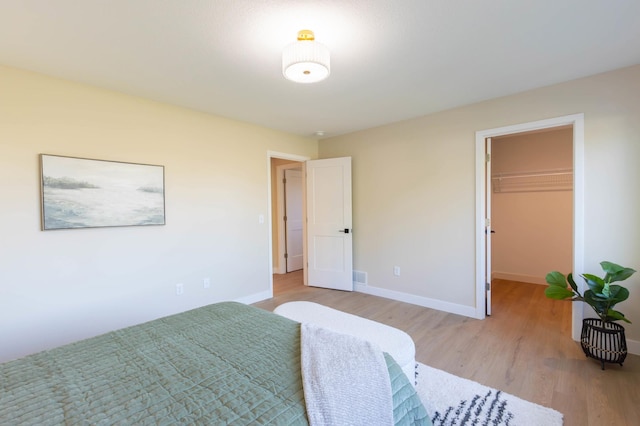 8464 Greenwood Dr, Mounds View, MN 55112 - bedroom featuring light wood-style floors, baseboards, and a spacious closet