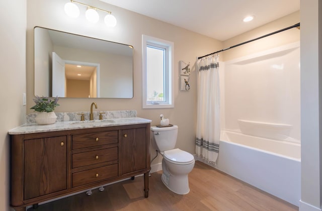 8464 Greenwood Dr, Mounds View, MN 55112 - bathroom featuring toilet, wood finished floors, vanity, and shower / bath combination with curtain