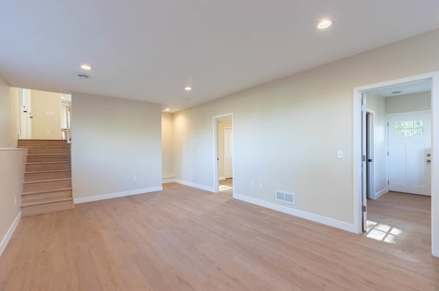 8464 Greenwood Dr, Mounds View, MN 55112 - unfurnished living room with light wood-style floors, baseboards, stairway, and recessed lighting