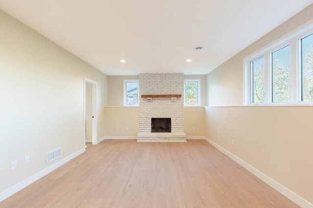 8464 Greenwood Dr, Mounds View, MN 55112 - unfurnished living room with light wood-style floors, baseboards, a fireplace, and recessed lighting