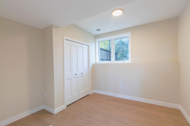 8464 Greenwood Dr, Mounds View, MN 55112 - unfurnished bedroom featuring light wood-type flooring, baseboards, and a closet