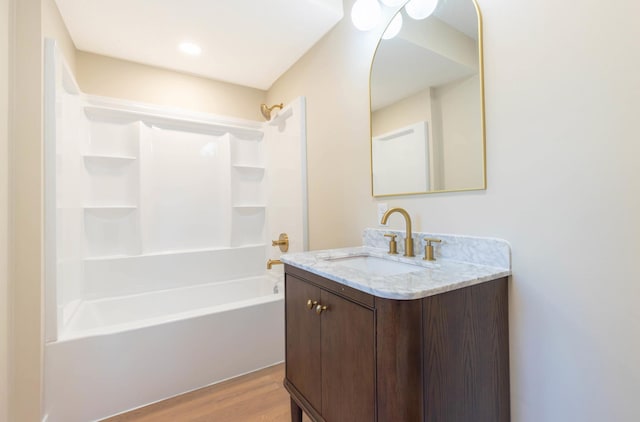8464 Greenwood Dr, Mounds View, MN 55112 - full bath with vanity, wood finished floors, and bathing tub / shower combination