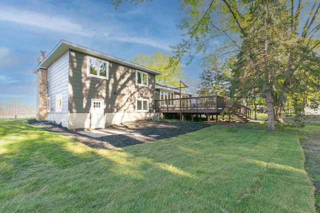8464 Greenwood Dr, Mounds View, MN 55112 - rear view of house featuring a wooden deck, a chimney, a lawn, and stairway
