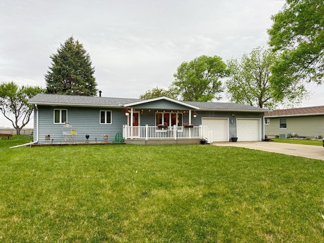120 10th St SE, Wells, MN 56097 - single story home with covered porch, a front lawn, driveway, and a garage