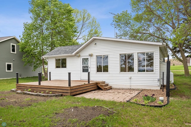 24527 Twilight Ln, Lida Twp, MN 56572 - rear view of house featuring a deck, a lawn, and roof with shingles