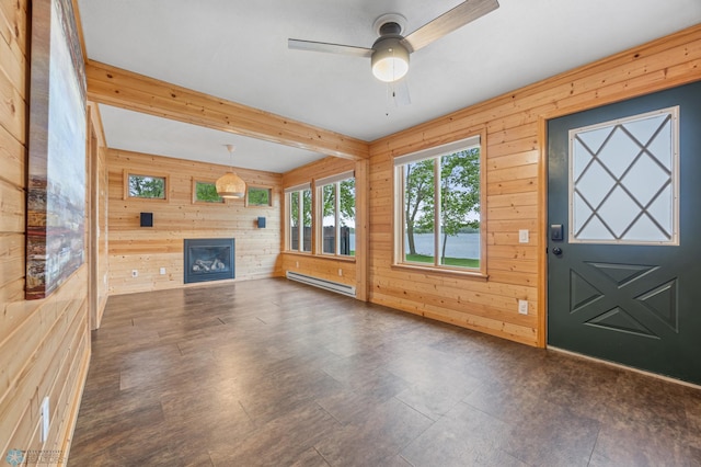 24527 Twilight Ln, Lida Twp, MN 56572 - unfurnished living room with wood walls, a baseboard heating unit, a glass covered fireplace, and ceiling fan