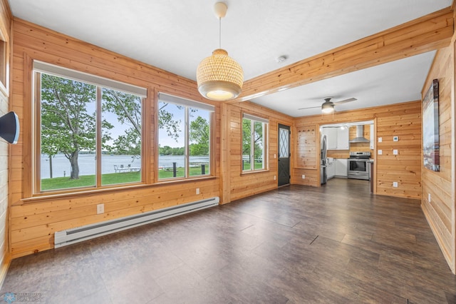 24527 Twilight Ln, Lida Twp, MN 56572 - unfurnished living room with a baseboard heating unit, wood walls, ceiling fan, and a water view
