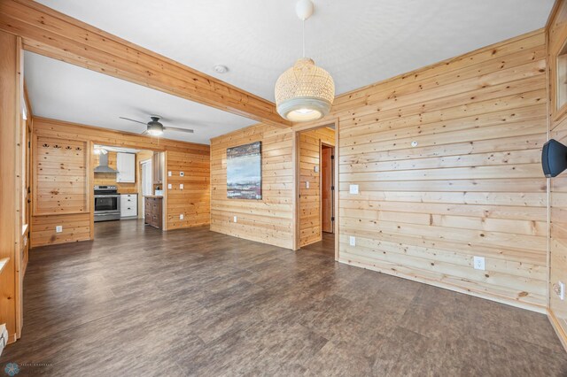 24527 Twilight Ln, Lida Twp, MN 56572 - unfurnished living room featuring wooden walls, dark wood-style floors, ceiling fan, and beamed ceiling
