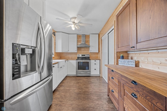 24527 Twilight Ln, Lida Twp, MN 56572 - kitchen featuring appliances with stainless steel finishes, wall chimney range hood, ceiling fan, white cabinets, and wood counters