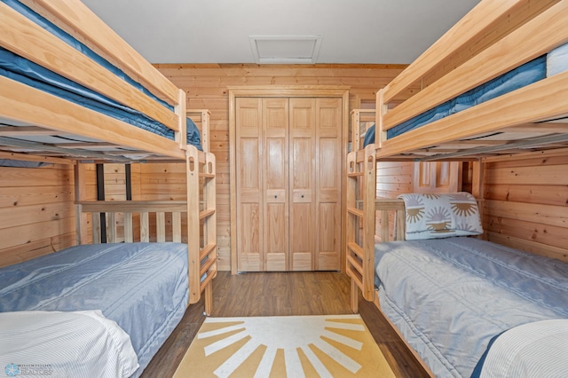 24527 Twilight Ln, Lida Twp, MN 56572 - bedroom with wooden walls, attic access, and wood finished floors