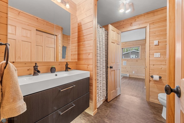 24527 Twilight Ln, Lida Twp, MN 56572 - bathroom featuring wooden walls, toilet, vanity, and a shower with shower curtain