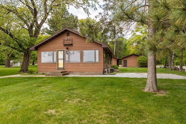 6769 County Road 13, Lake Edward Twp, MN 56468 - view of front of home with entry steps, a front yard, and central air condition unit