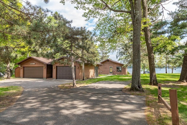 6769 County Road 13, Lake Edward Twp, MN 56468 - single story home with a water view, asphalt driveway, and a front lawn