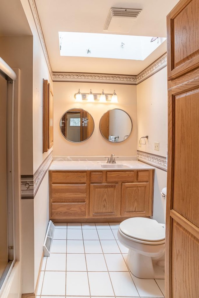 6769 County Road 13, Lake Edward Twp, MN 56468 - full bathroom featuring vanity, toilet, tile patterned flooring, a shower, and a skylight
