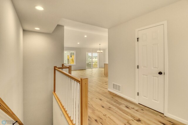1474 66th Ave S, Fargo, ND 58104 - corridor with an upstairs landing, recessed lighting, light wood finished floors, a chandelier, and baseboards